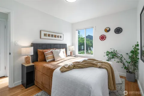 a bedroom with a bed and a potted plant