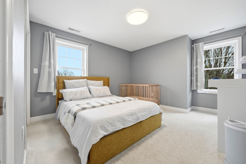30 Webster Street, Unit 3 Needham, MA 02494 - Photo 30 of 38 a bedroom with a bed and a window