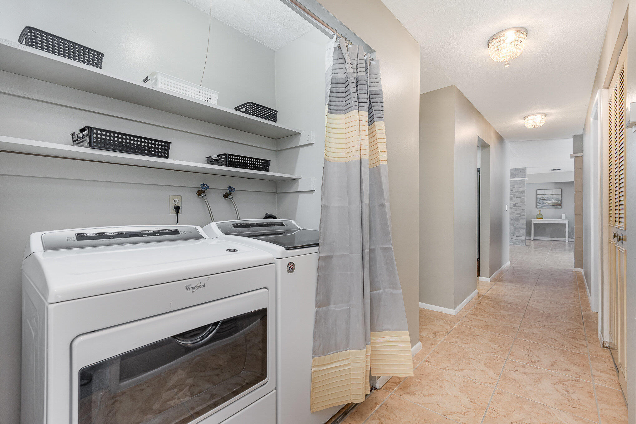 941 Levitt Parkway Rockledge, FL 32955 - Photo 18 of 33 a view of washer and dryer with kitchen in the background