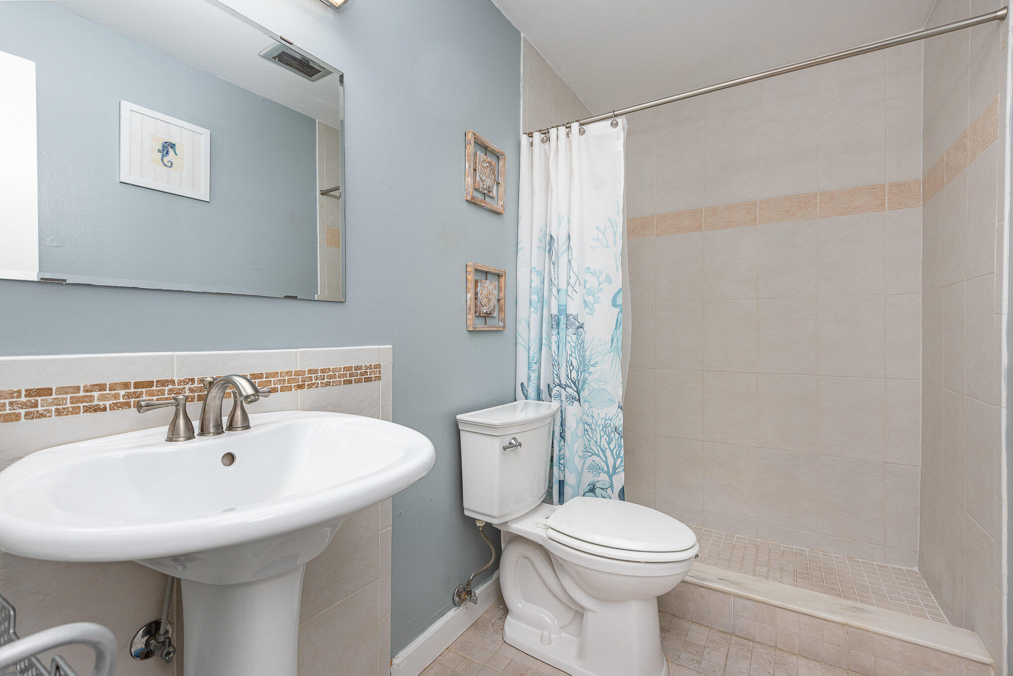 941 Levitt Parkway Rockledge, FL 32955 - Photo 19 of 33 a bathroom with a sink a toilet and shower