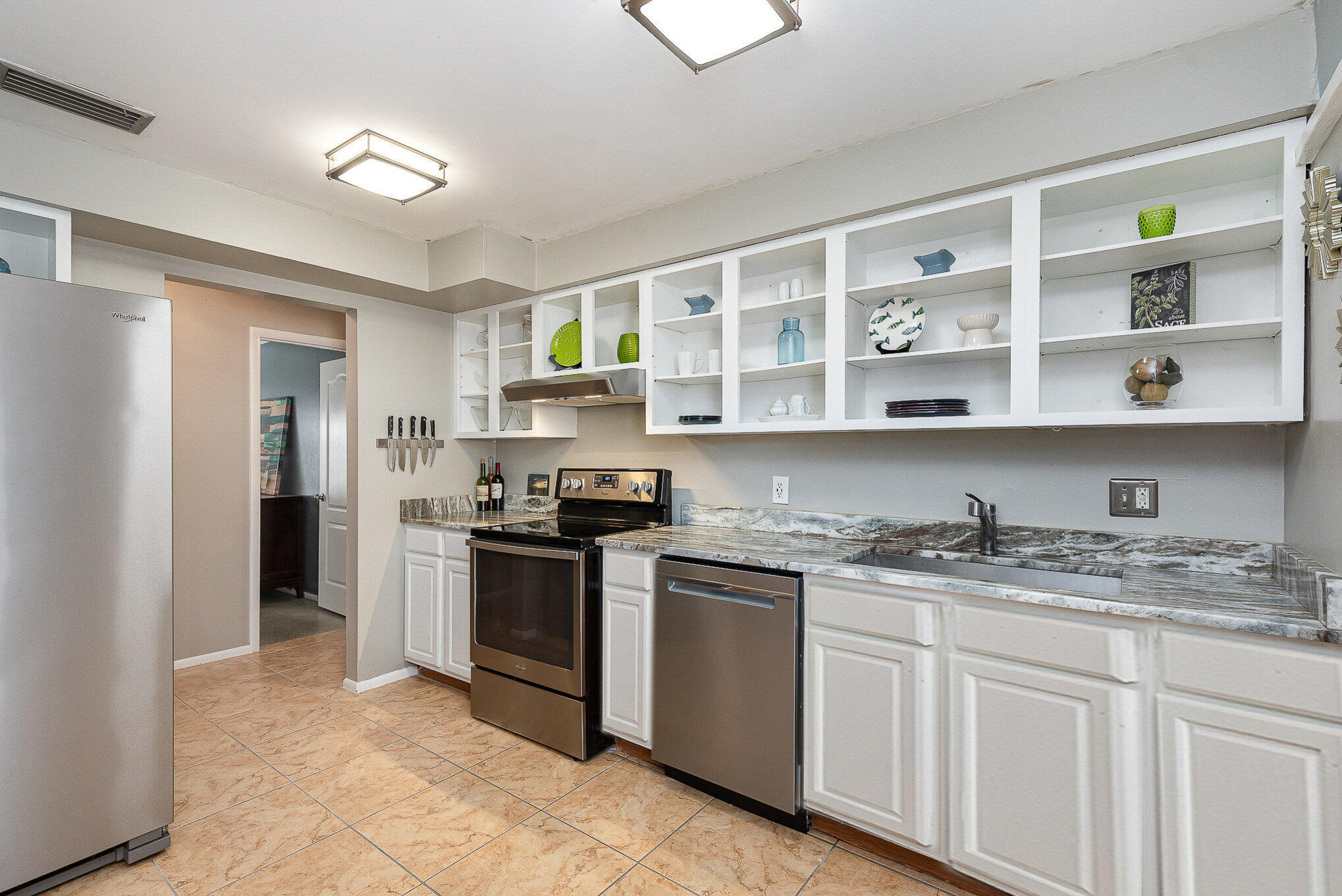 941 Levitt Parkway Rockledge, FL 32955 - Photo 5 of 33 a kitchen with stainless steel appliances granite countertop a stove sink and cabinets