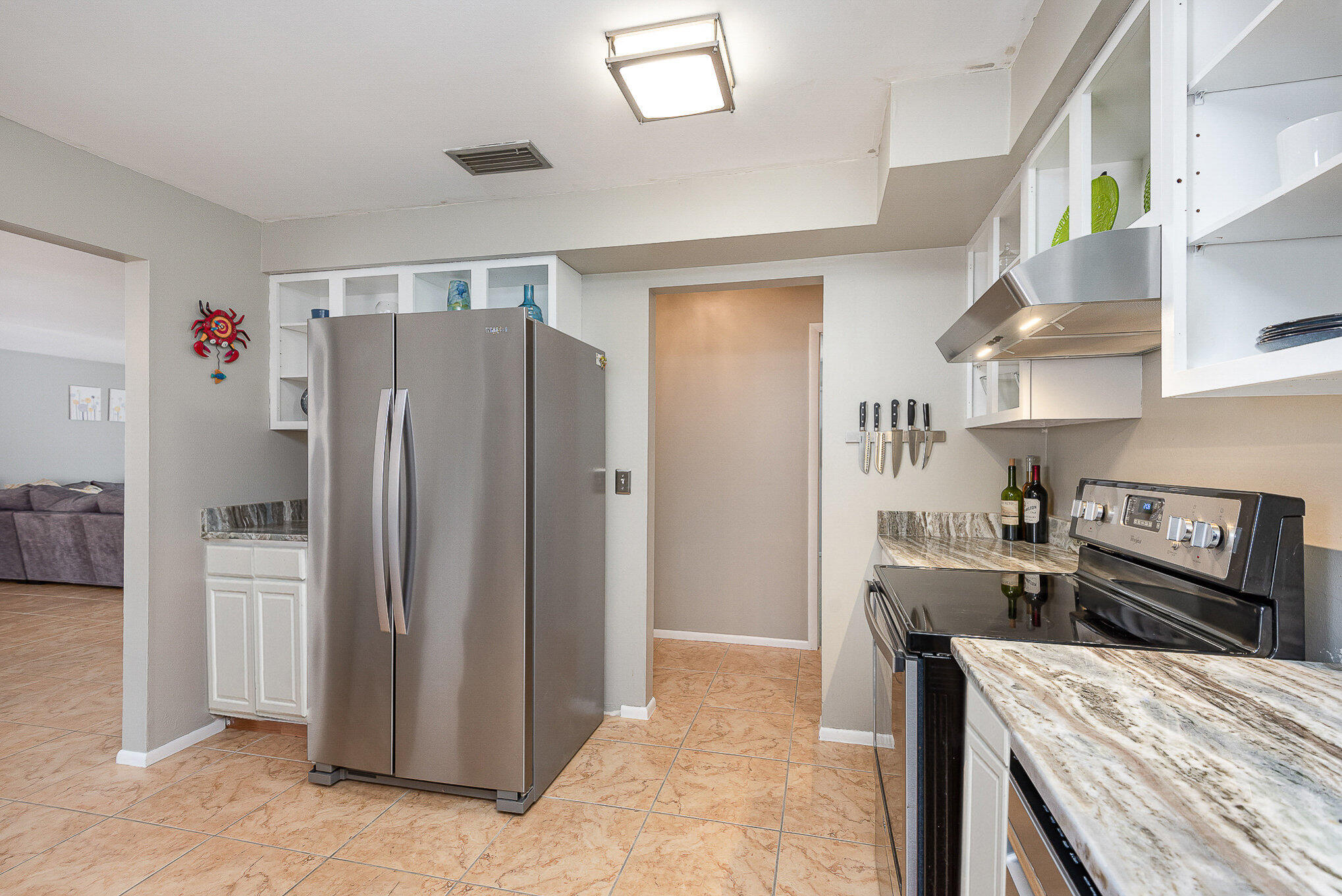 941 Levitt Parkway Rockledge, FL 32955 - Photo 6 of 33 a kitchen with stainless steel appliances granite countertop a refrigerator and a stove