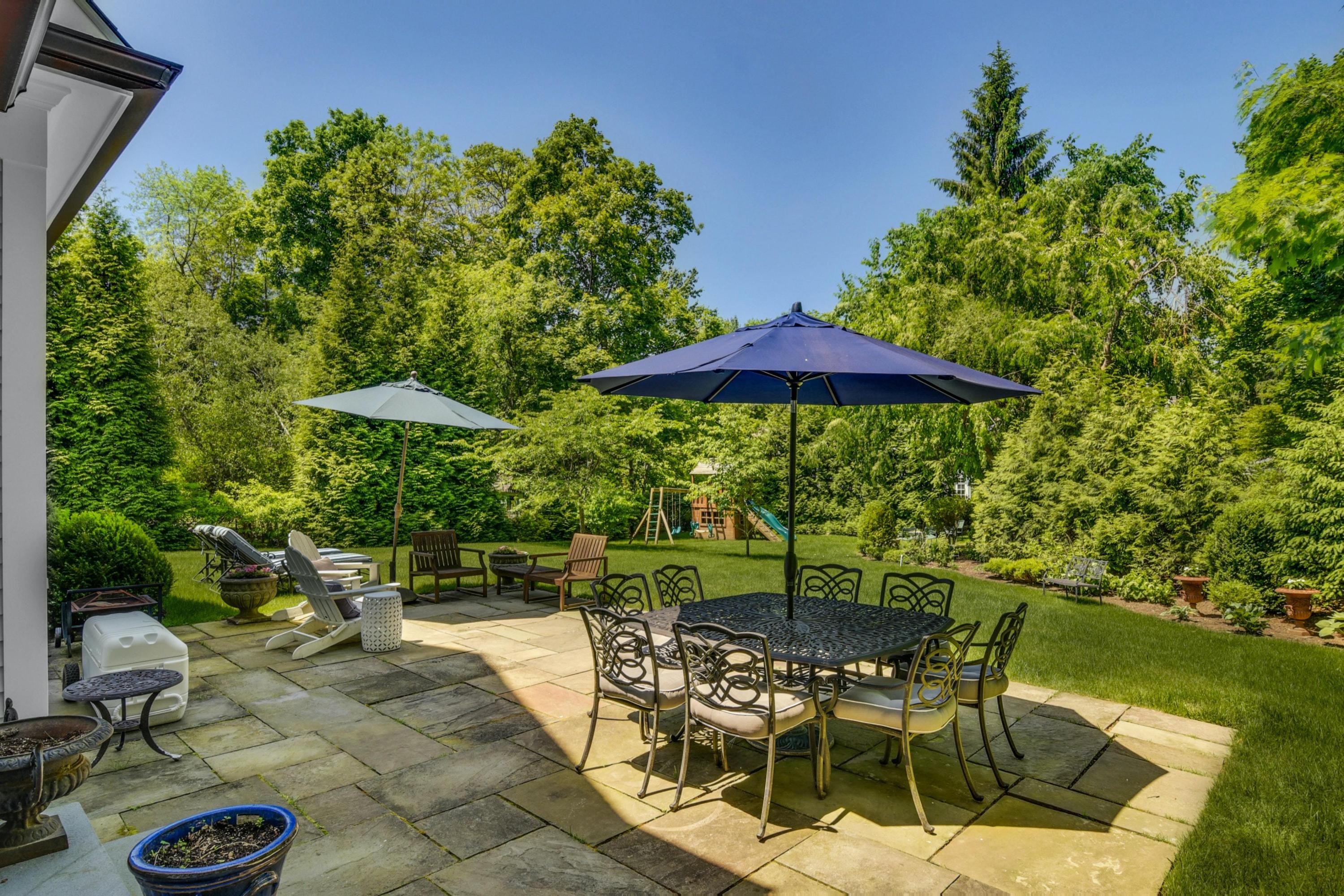 2271 Boston Post Road Darien, CT 06820 - Photo 27 of 40 a view of a chairs and table in backyard