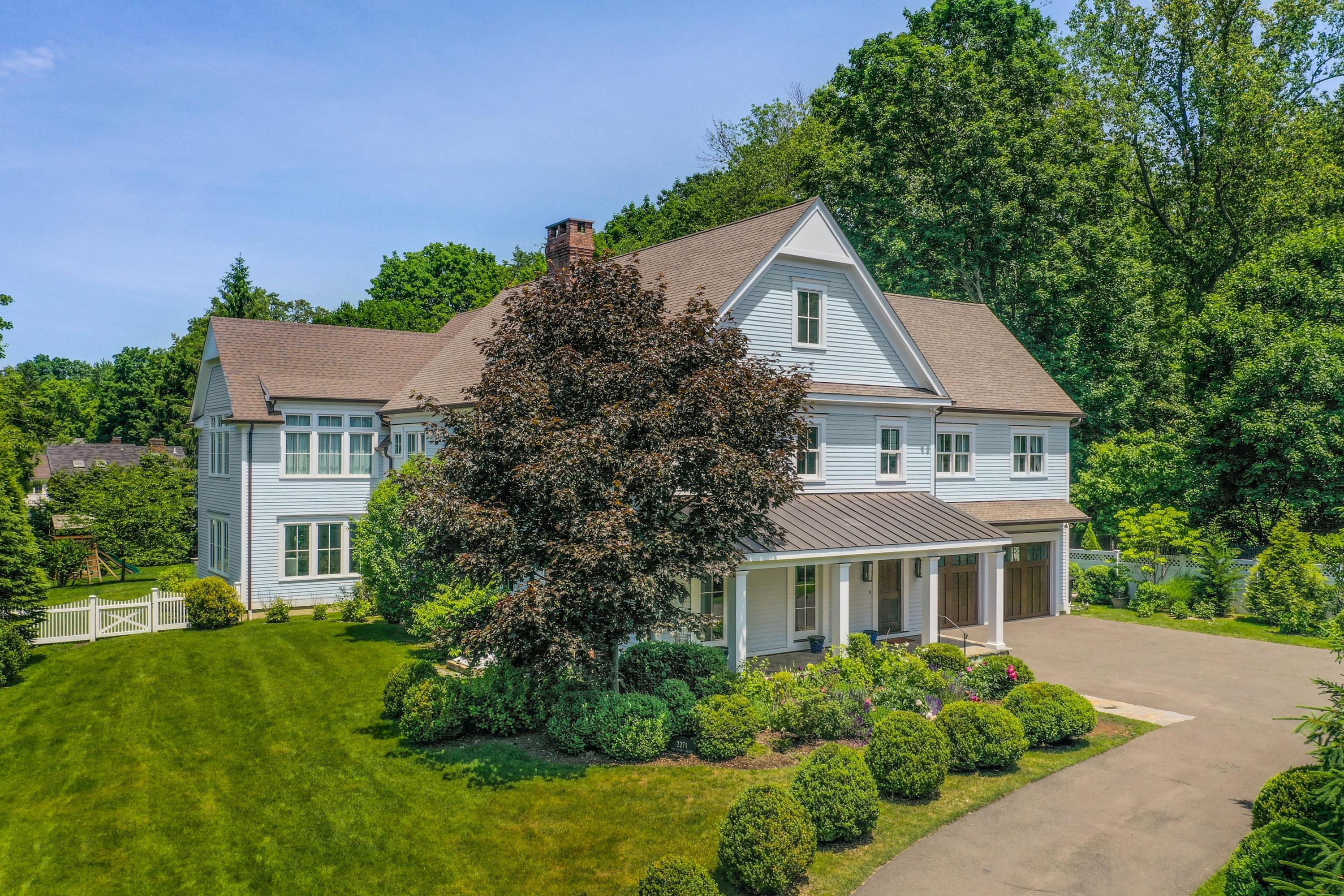 2271 Boston Post Road Darien, CT 06820 - Photo 31 of 40 a front view of a house with a yard and garage