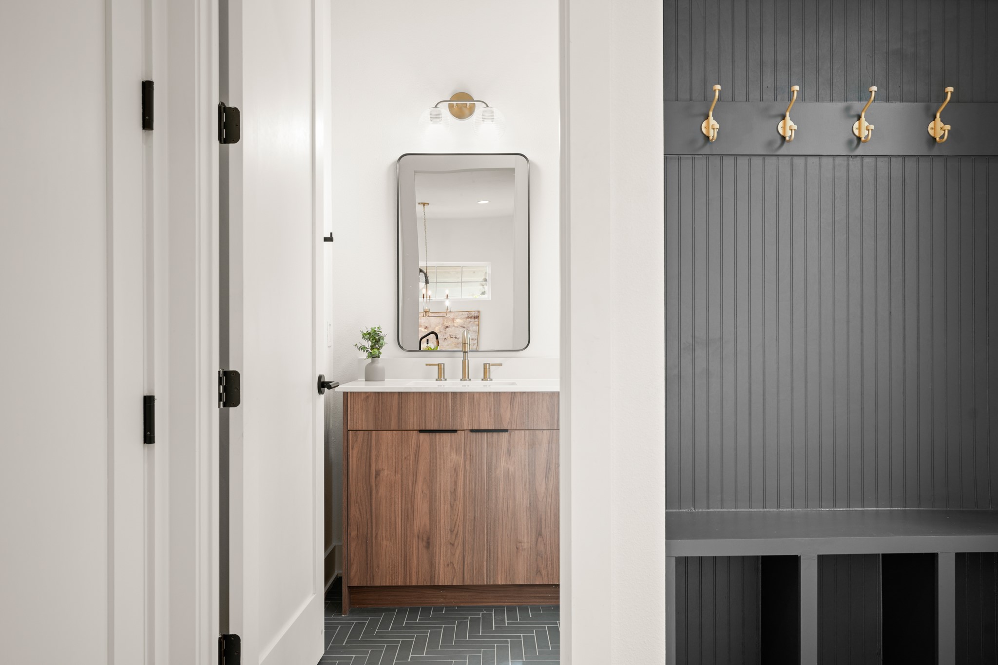 601 Vermont Road, Unit 2 Austin, TX 78702 - Photo 18 of 31 Herringbone tile flooring enhances this well-appointed bathroom with a sleek wooden vanity.