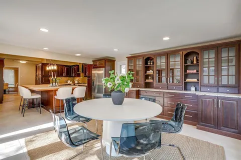 a view of a dining room with furniture and a potted plant