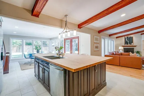 a kitchen with stainless steel appliances granite countertop a stove and a kitchen island