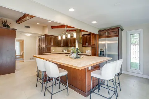 a large kitchen with a table and chairs