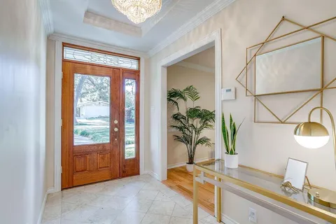 a bathroom with a granite countertop sink a mirror and next to a window