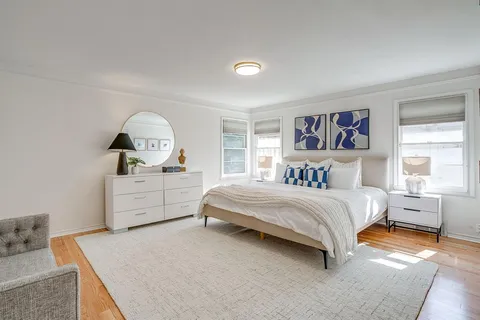 a bedroom with a bed and a dresser