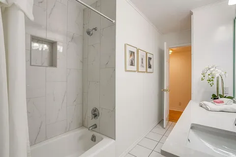 a bathroom with a tub shower and sink