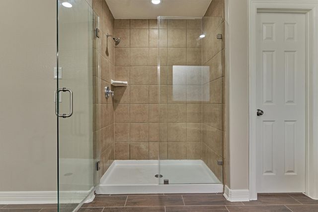 a bathroom with a bathtub and shower