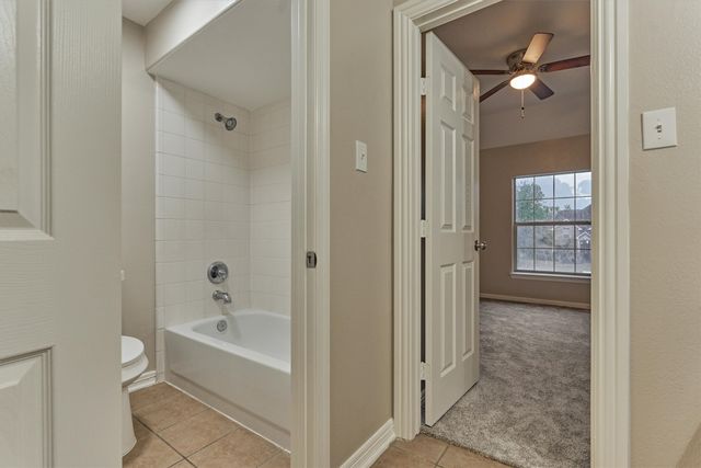a bathroom with a bathtub and shower
