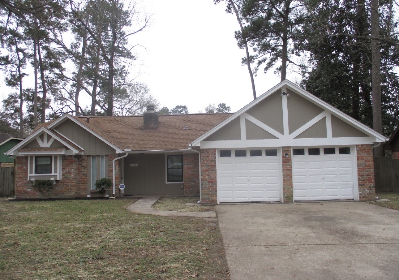 2106 Woodway Drive Woodbranch, TX 77357 - Photo 1 of 17 a view of outdoor space yard and garage