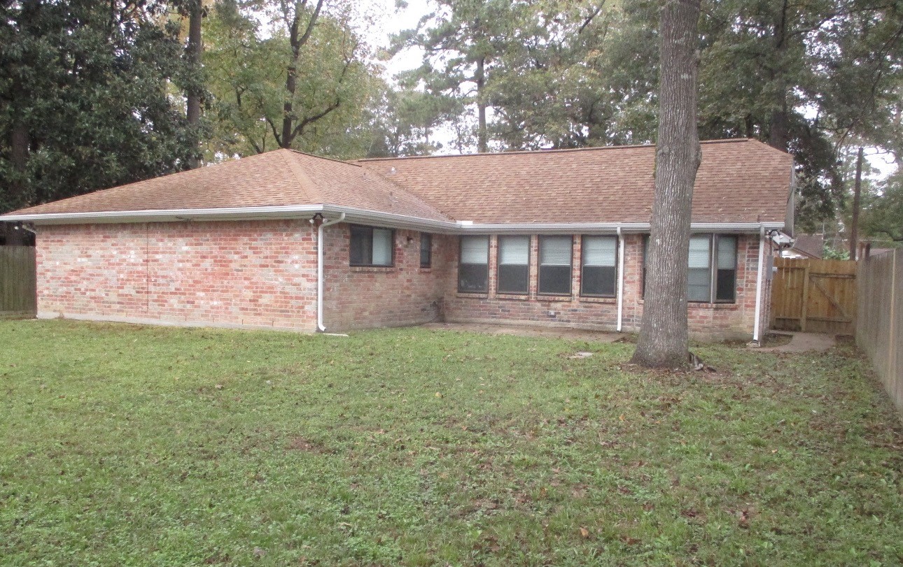 2106 Woodway Drive Woodbranch, TX 77357 - Photo 17 of 17 a view of front of a house with a yard