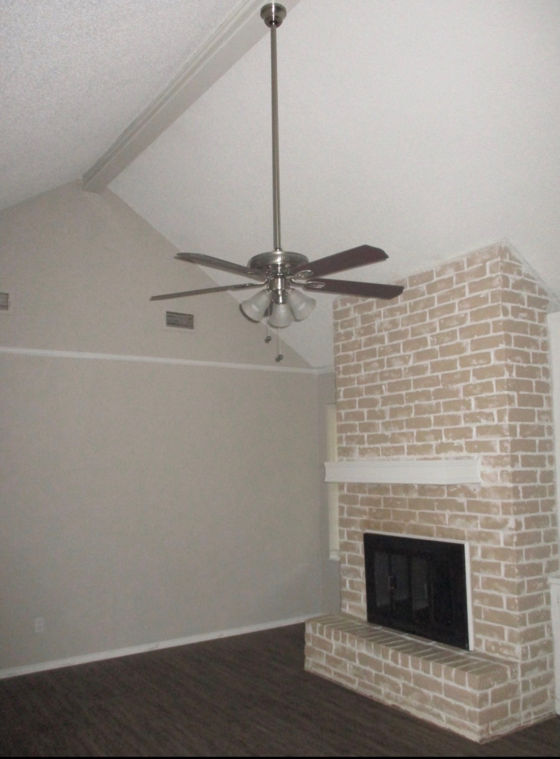 2106 Woodway Drive Woodbranch, TX 77357 - Photo 4 of 17 a room with a fireplace and a ceiling fan