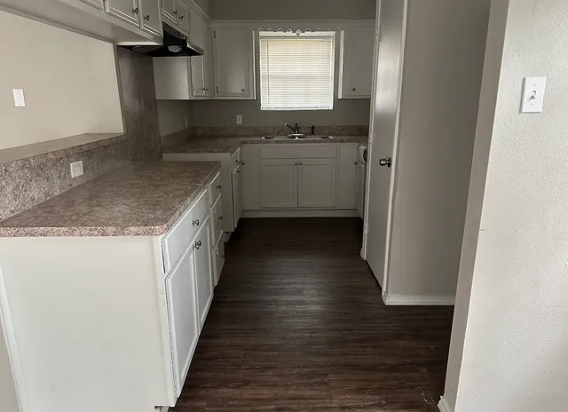 a kitchen with stainless steel appliances granite countertop a sink and a stove top oven