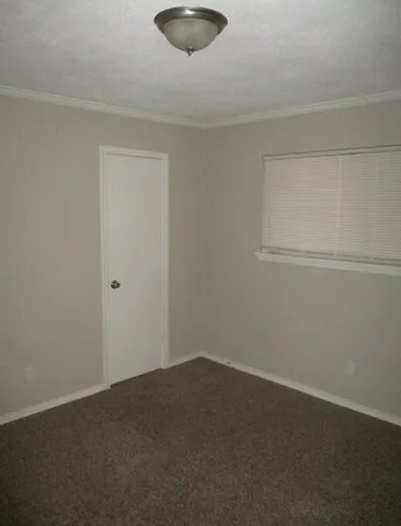 a view of a room with a ceiling fan and a ceiling fan