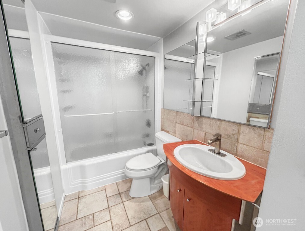 4561 Lake Washington Boulevard Northeast, Unit 303 Kirkland, WA 98033 - Photo 12 of 16 a bathroom with a sink toilet and shower
