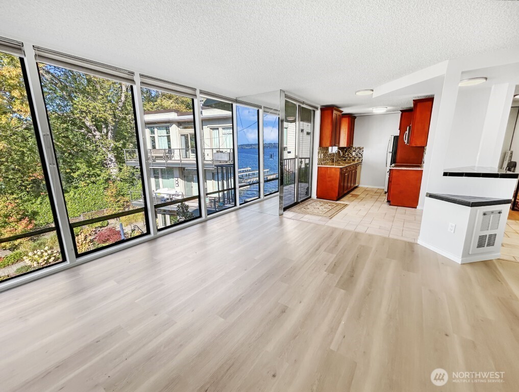 4561 Lake Washington Boulevard Northeast, Unit 303 Kirkland, WA 98033 - Photo 7 of 16 a room with wooden floor and furniture