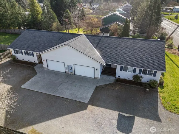 an aerial view of a house with a yard