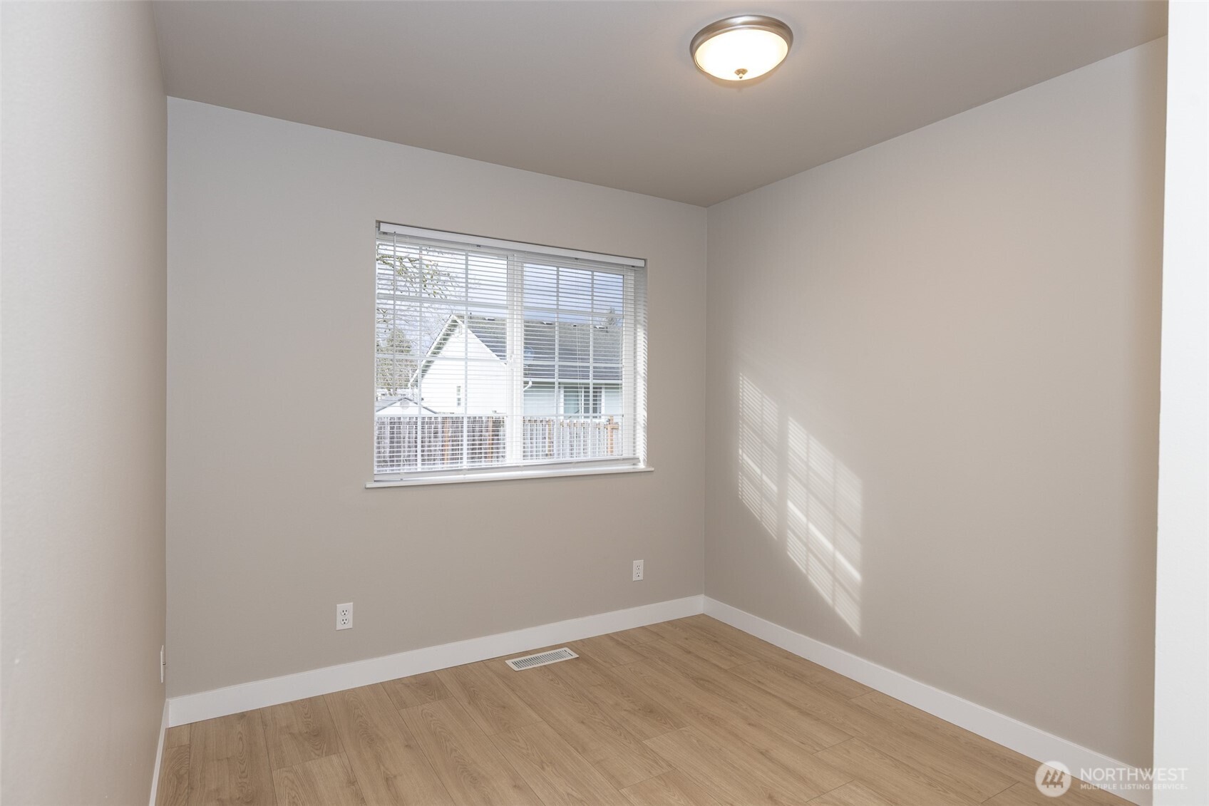 105 May Creek Road Gold Bar, WA 98251 - Photo 12 of 38 an empty room with wooden floor and windows