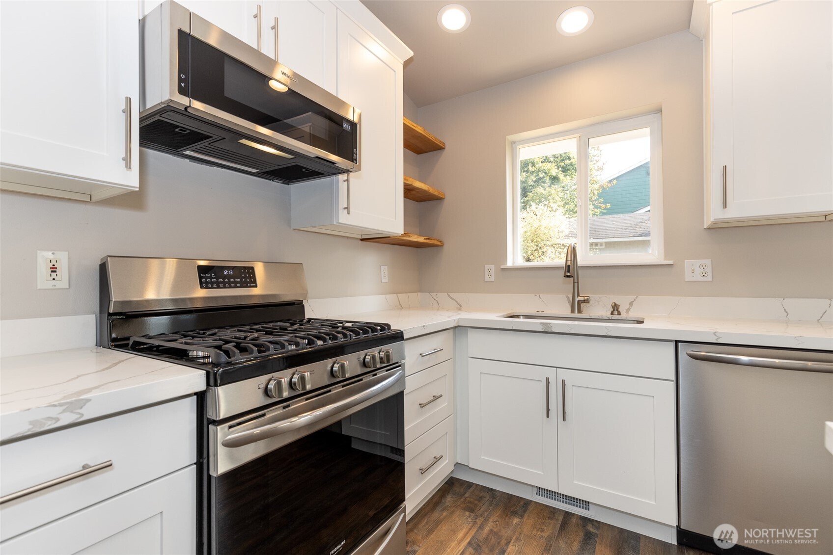 105 May Creek Road Gold Bar, WA 98251 - Photo 23 of 38 a kitchen with stainless steel appliances a stove a sink and wooden cabinets
