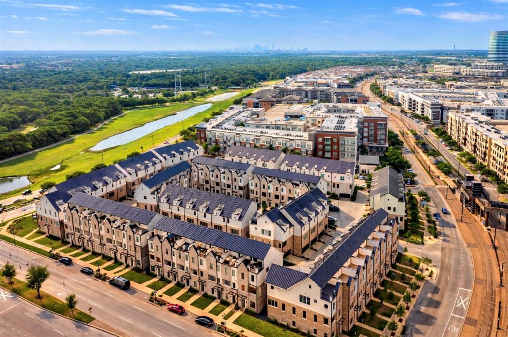 5421 Patterson Street Irving, TX 75039 - Photo 18 of 32 Aerial perspective showcasing a collection of multi-story residential buildings with dark roofs and light-colored facades