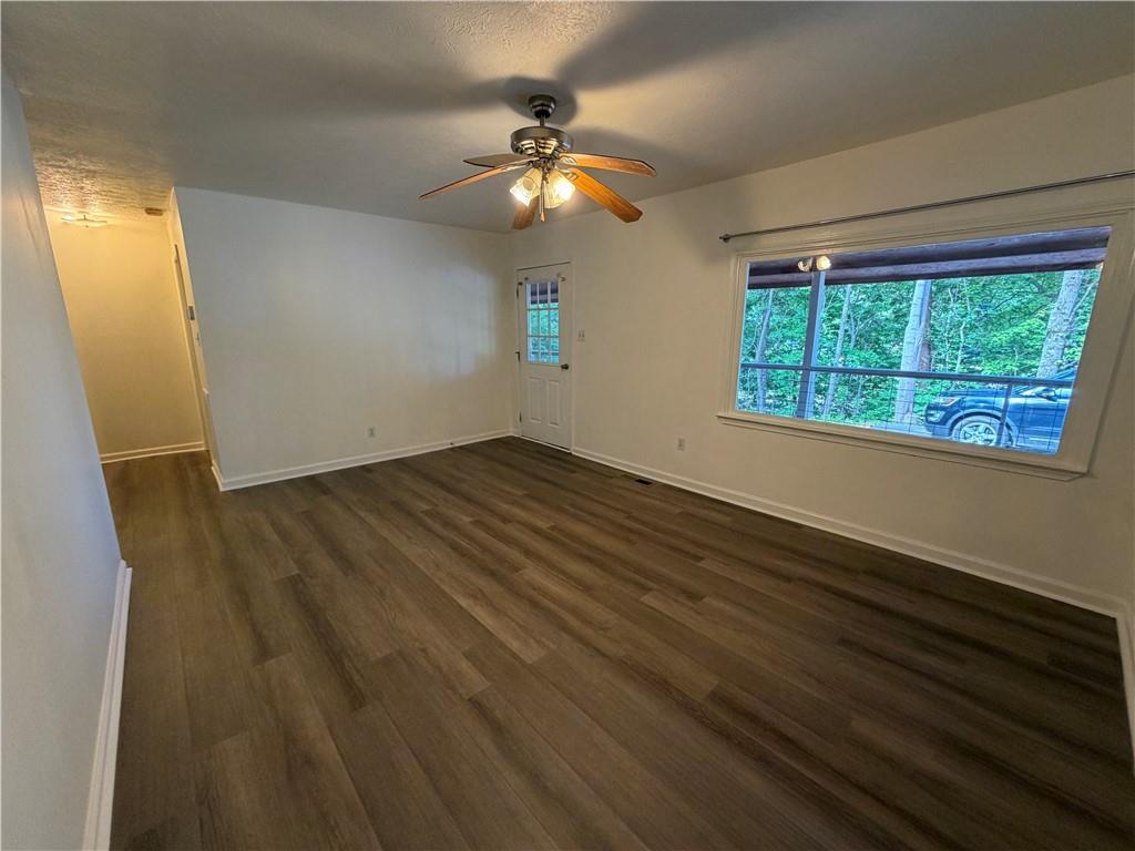 86 Robert Jones Road Dawsonville, GA 30534 - Photo 5 of 19 wooden floor in an empty room with a window