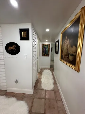 a view of a hallway with paintings on the wall