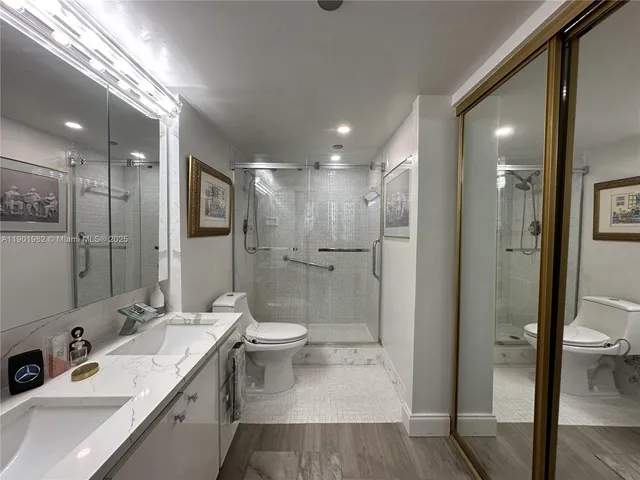 a bathroom with a sink a toilet and shower