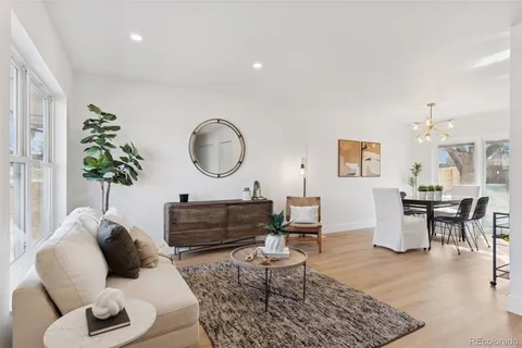 a living room with furniture a rug and a table