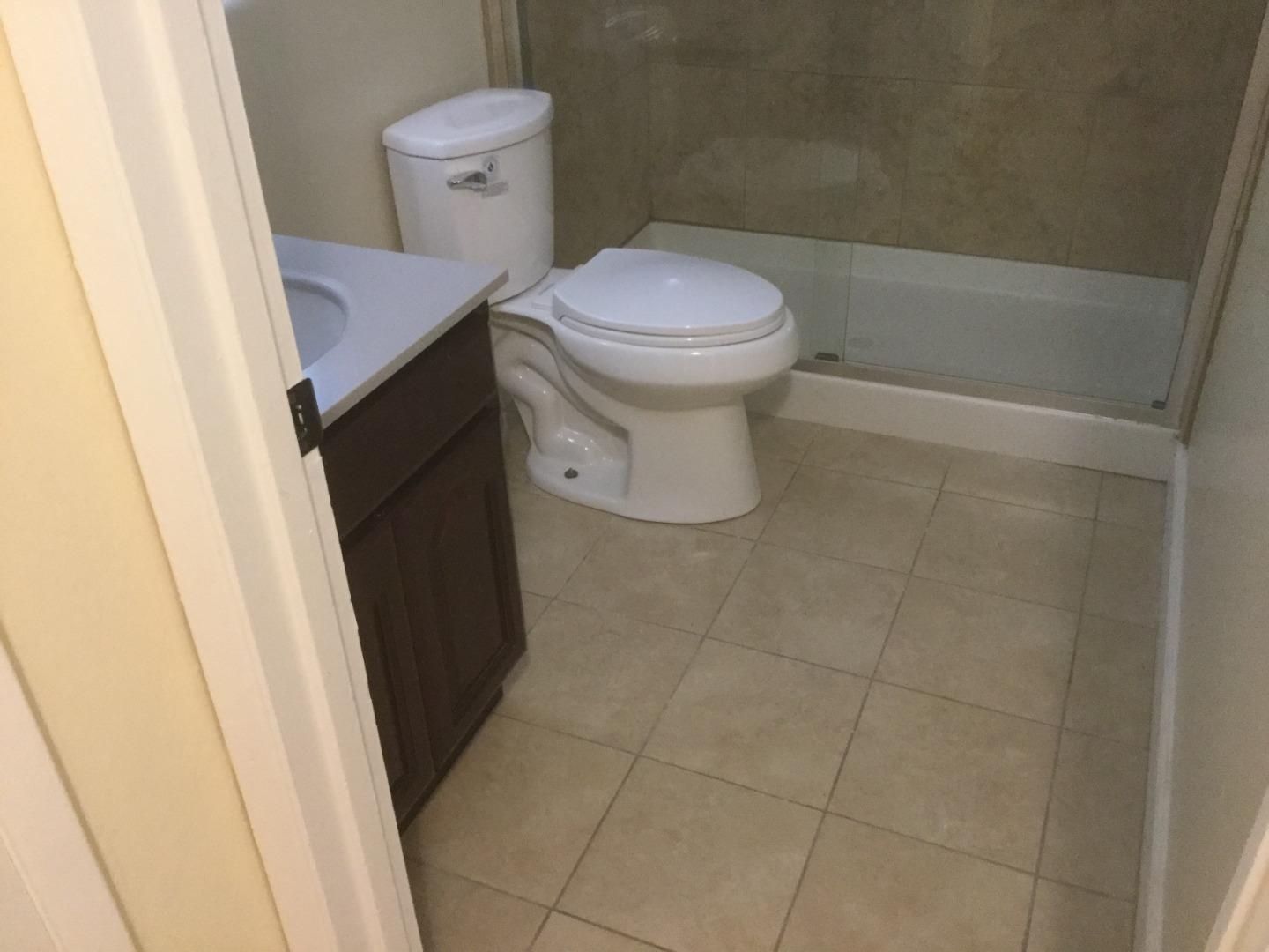 Peralta Street Hayward, CA 94541 - Photo 10 of 17 a white toilet sitting next to a sink