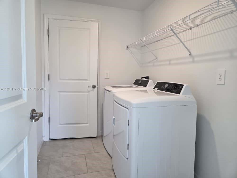 3403 34th Street Southwest, Unit 3403 Lehigh Acres, FL 33976 - Photo 12 of 16 a utility room with dryer and washer