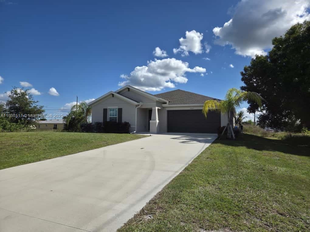 3403 34th Street Southwest, Unit 3403 Lehigh Acres, FL 33976 - Photo 2 of 16 a front view of a house with garden
