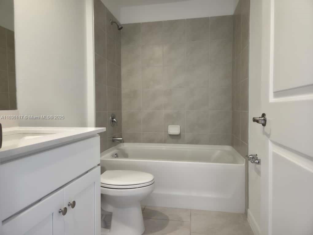 3403 34th Street Southwest, Unit 3403 Lehigh Acres, FL 33976 - Photo 10 of 16 a bathroom with a toilet a sink and bathtub