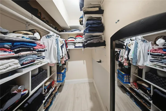 a bathroom with a granite countertop sink mirror vanity and toilet