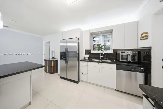 a kitchen with a refrigerator and a sink