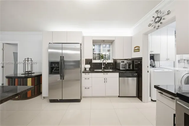 a kitchen with stainless steel appliances a refrigerator sink and stove