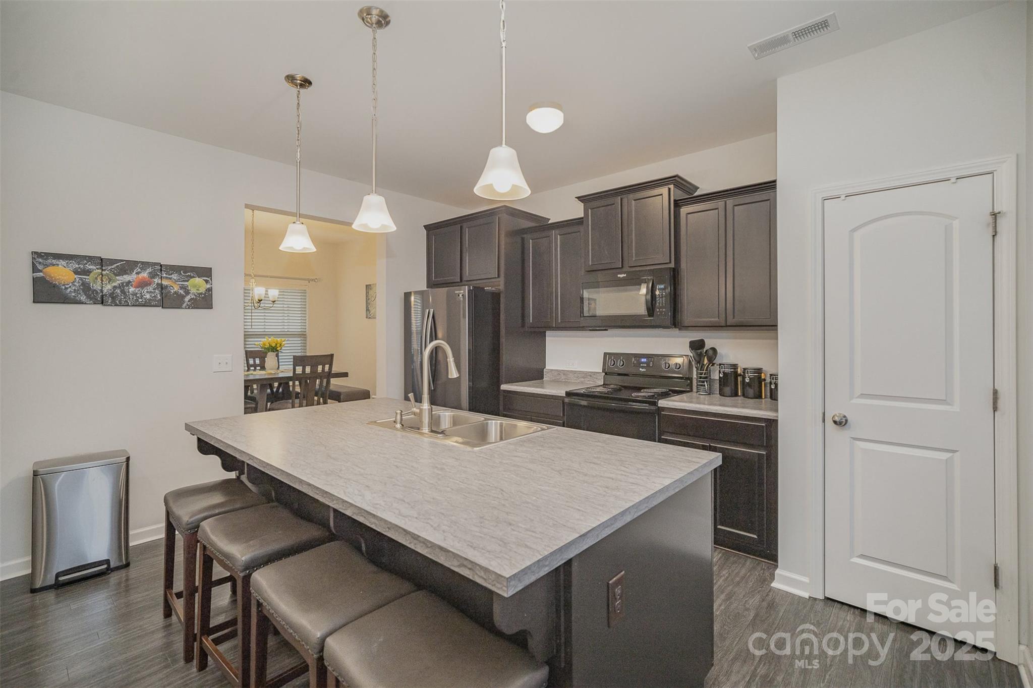 12531 Gotland Road Midland, NC 28107 - Photo 8 of 20 a kitchen with a stove a refrigerator and a dining table