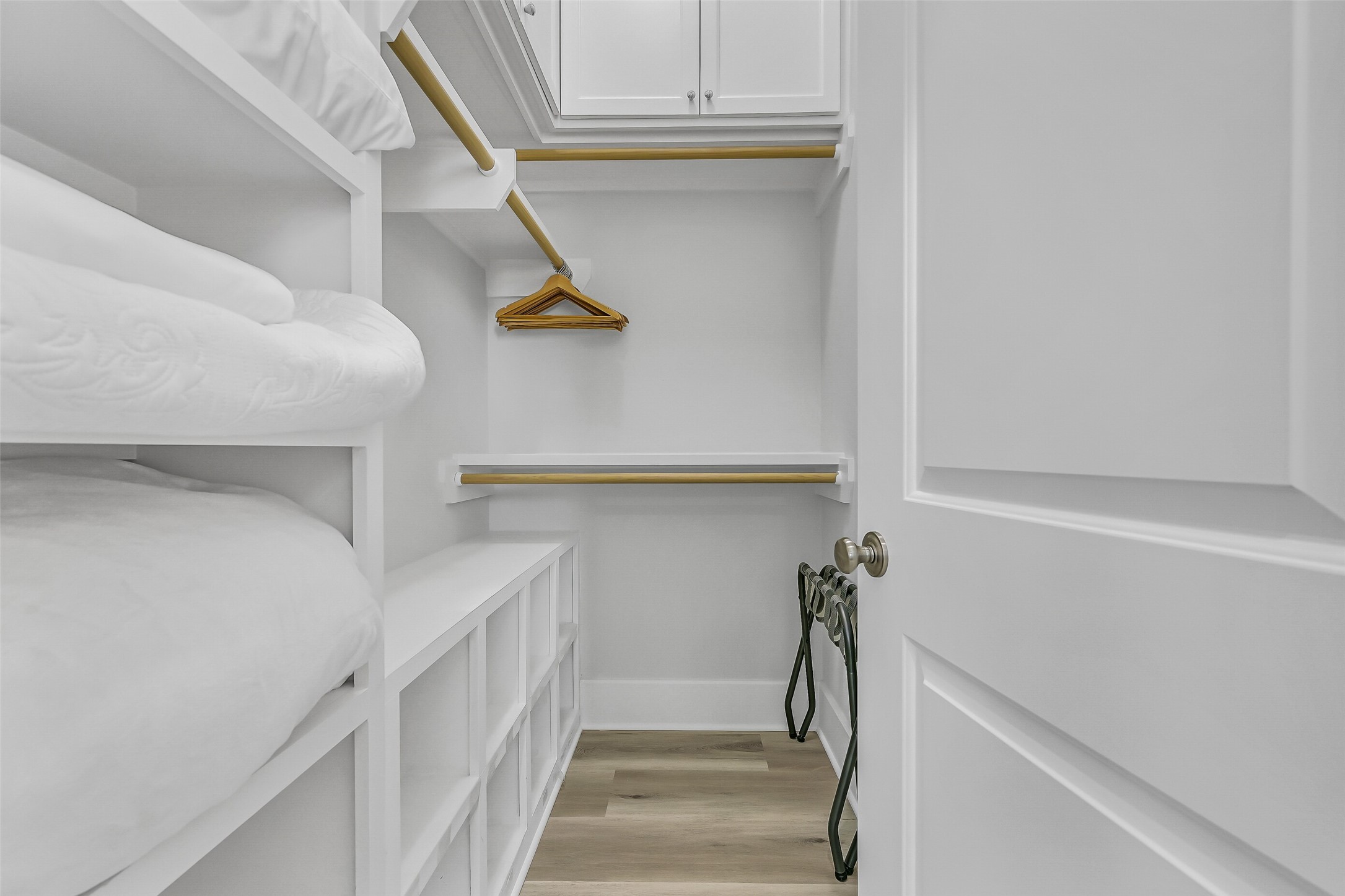 817 Positano Road Galveston, TX 77550 - Photo 28 of 50 Designed for convenience and extended stays, this spacious walk-in closet provides exceptional storage and organization. Built-in shelving and custom cabinetry ensure there's a place for everything.