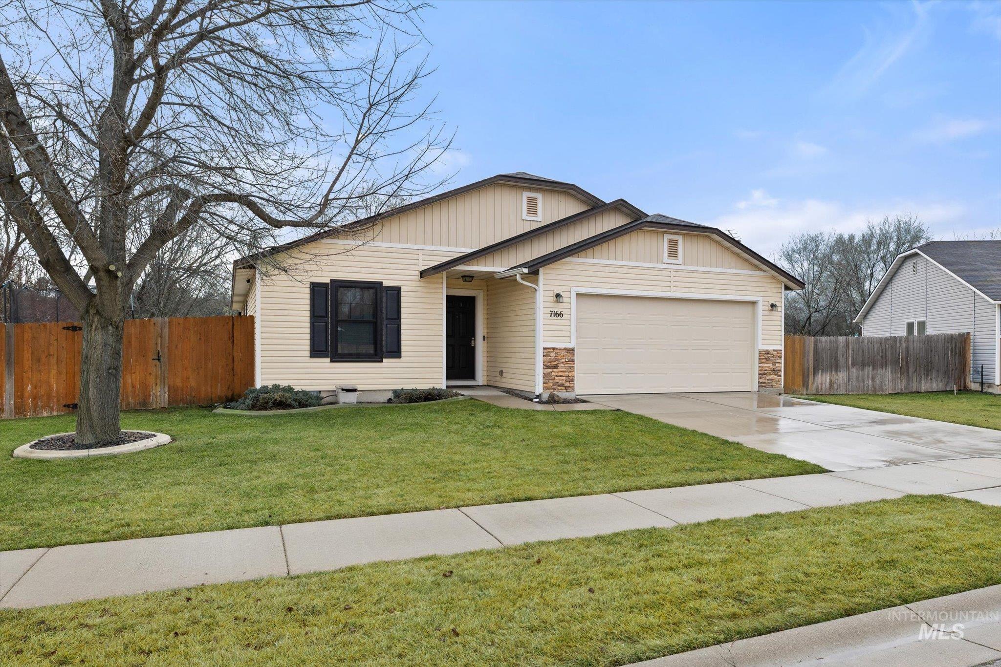 7166 Yellow Fern Road Nampa, ID 83687 - Photo 2 of 35 View of front facade with concrete driveway and an attached garage