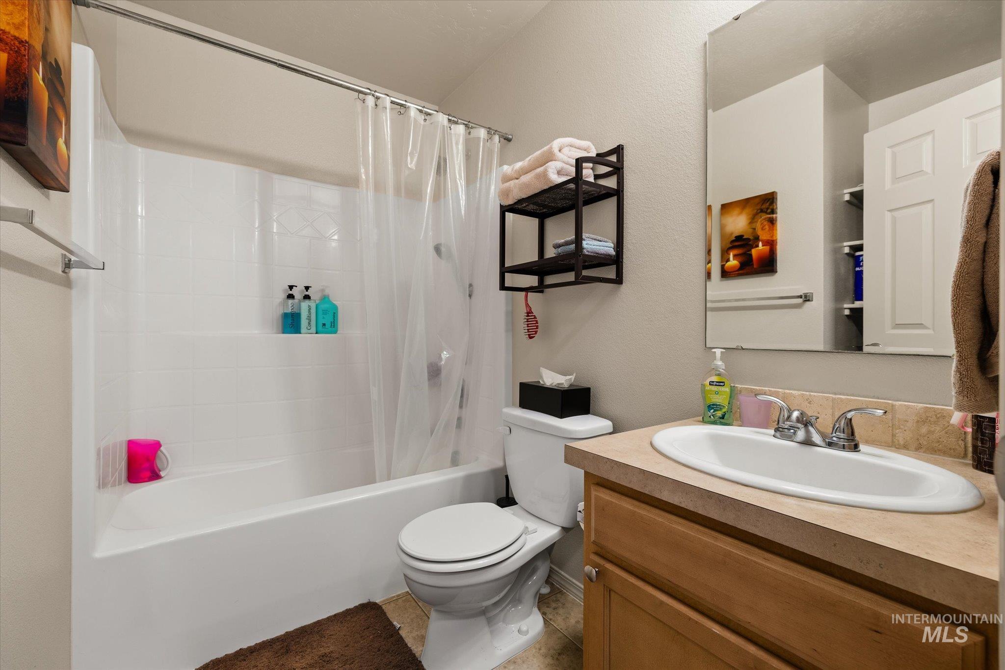 7166 Yellow Fern Road Nampa, ID 83687 - Photo 25 of 35 Full bath featuring vanity, shower / bath combo, and a textured wall