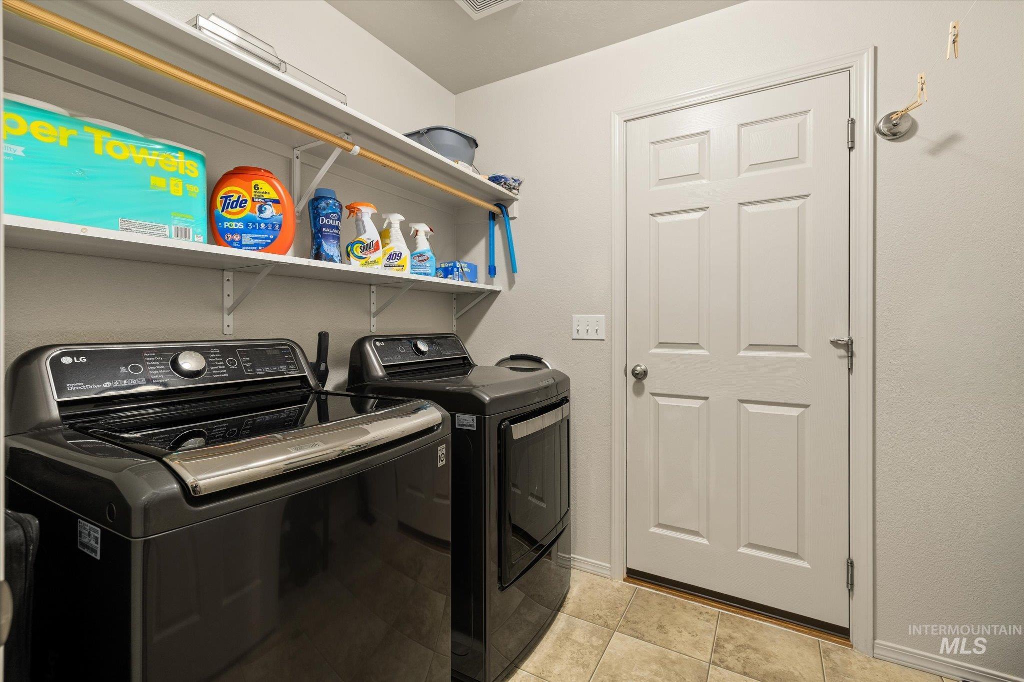 7166 Yellow Fern Road Nampa, ID 83687 - Photo 27 of 35 Laundry area with washer and clothes dryer and light tile patterned flooring