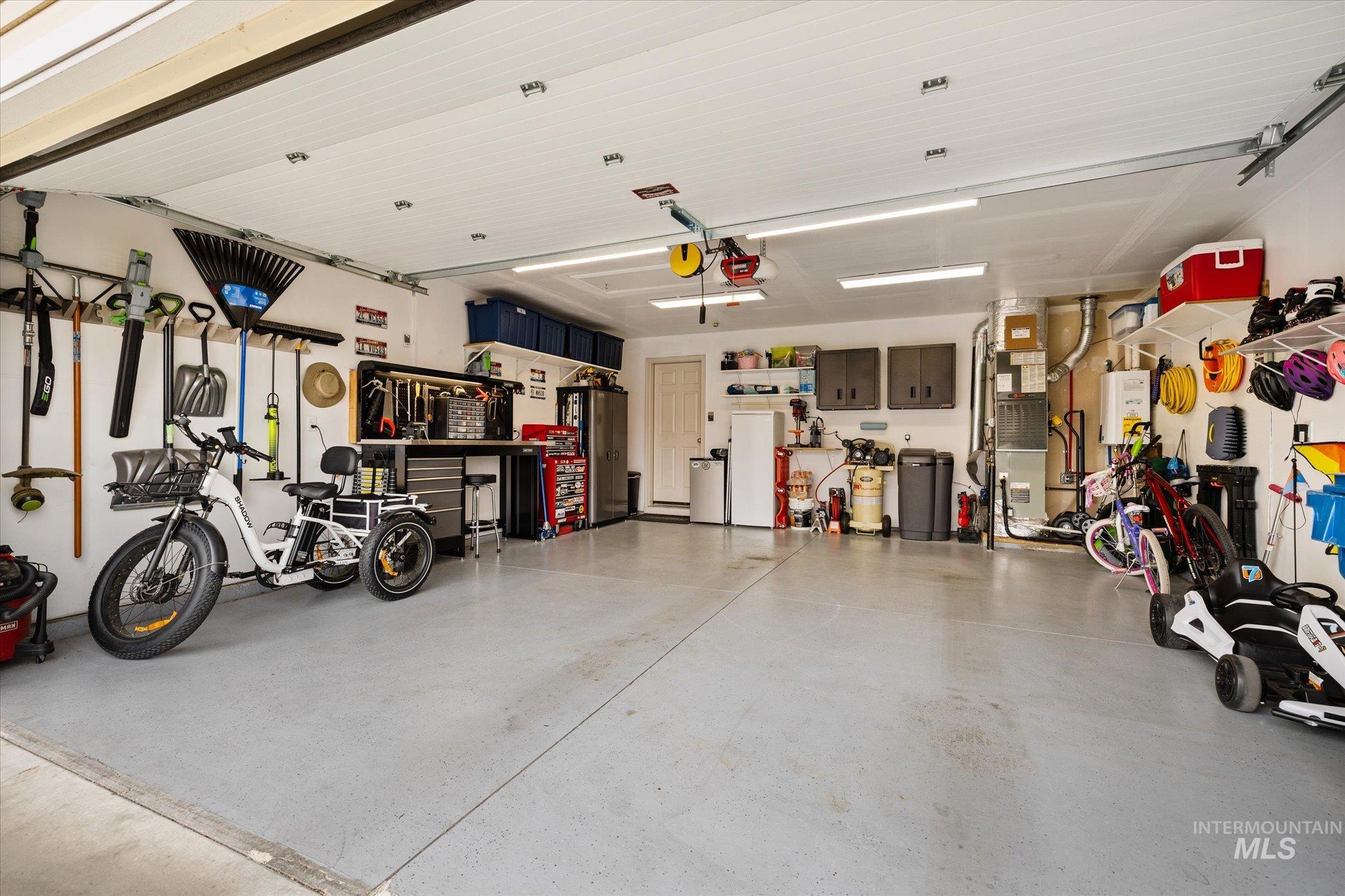 7166 Yellow Fern Road Nampa, ID 83687 - Photo 28 of 35 Garage featuring heating unit and water heater