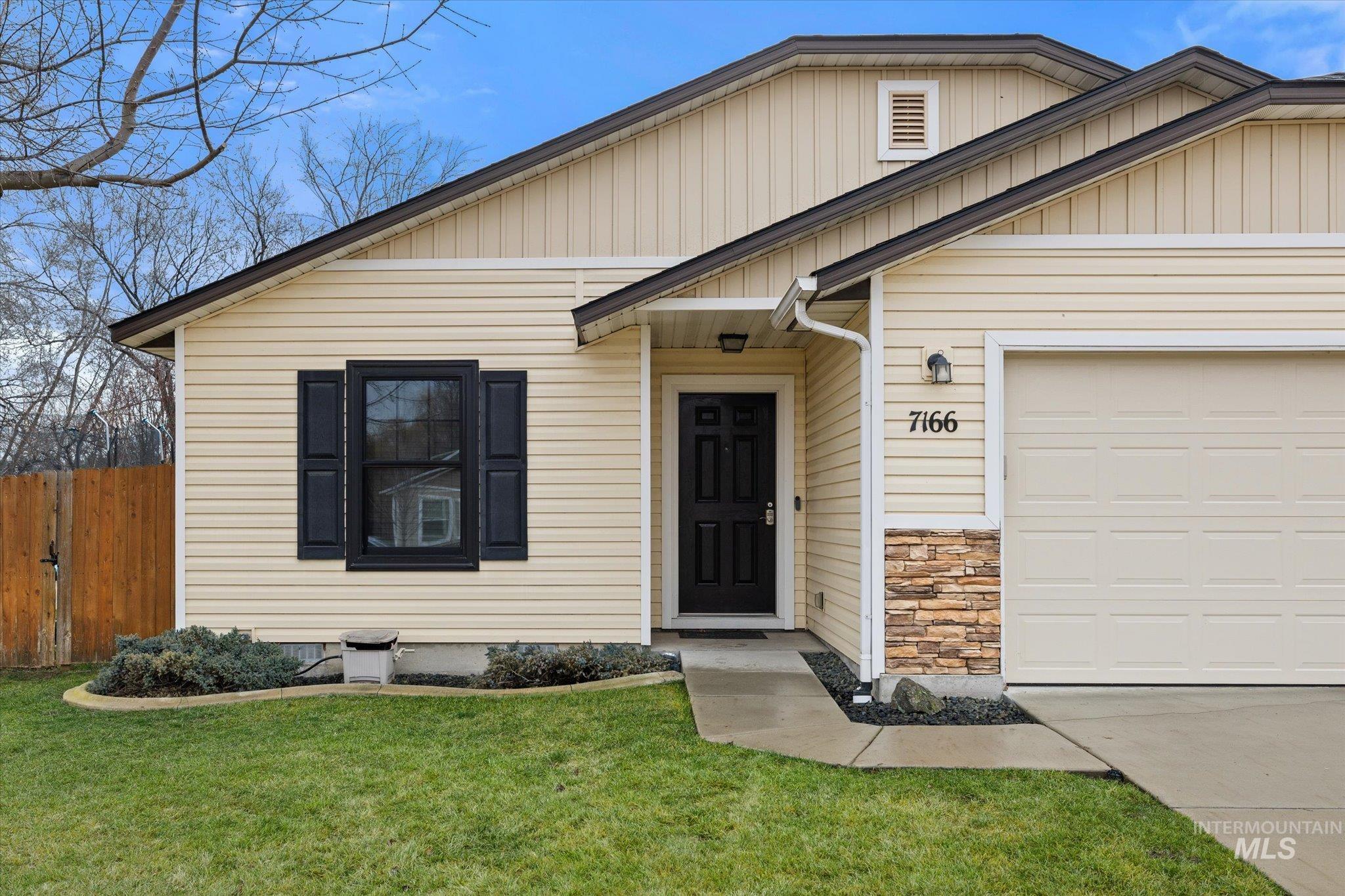 7166 Yellow Fern Road Nampa, ID 83687 - Photo 3 of 35 View of front of property with an attached garage, concrete driveway, and stone siding