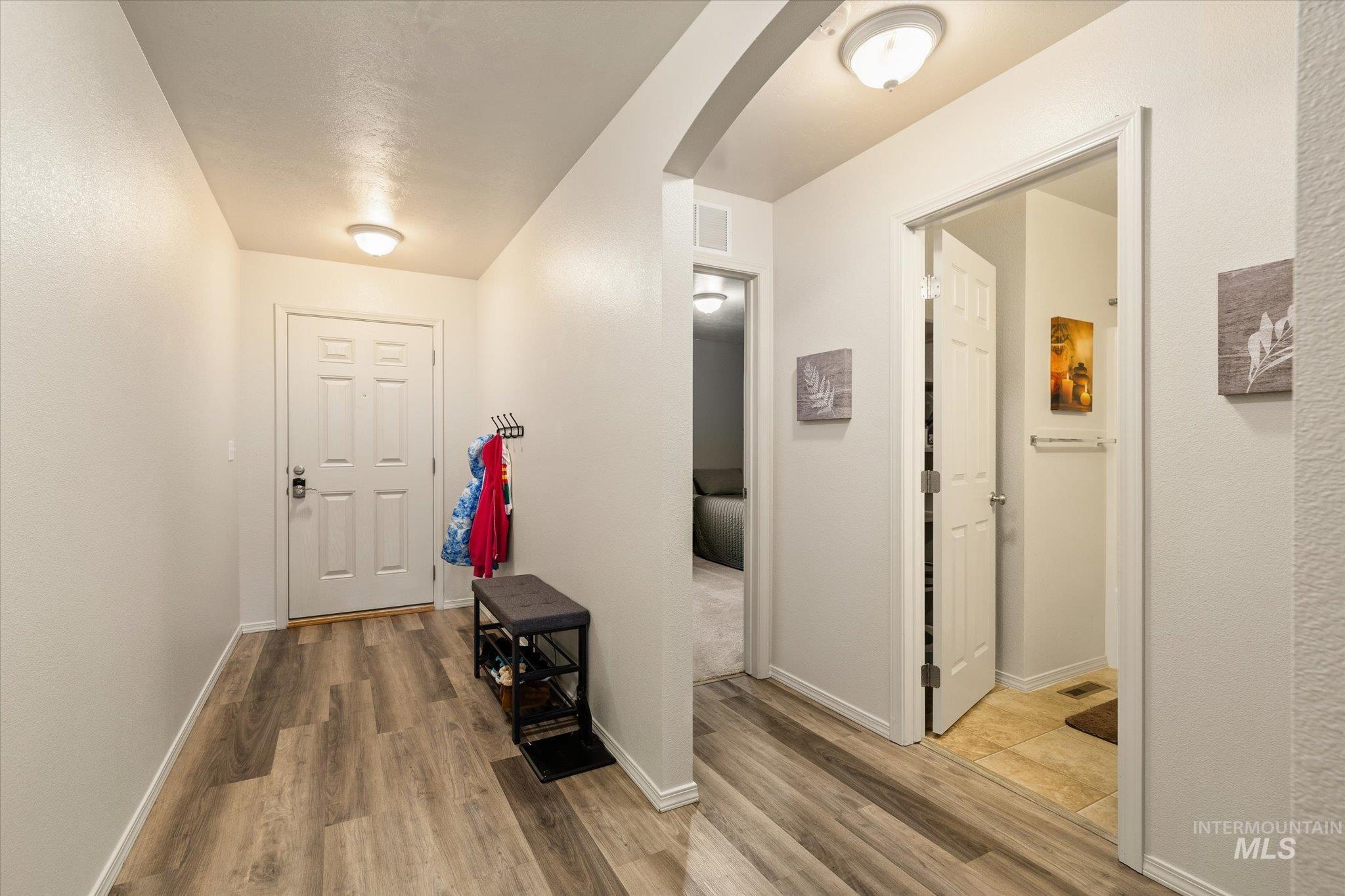 7166 Yellow Fern Road Nampa, ID 83687 - Photo 4 of 35 Hall featuring light wood-type flooring and arched walkways