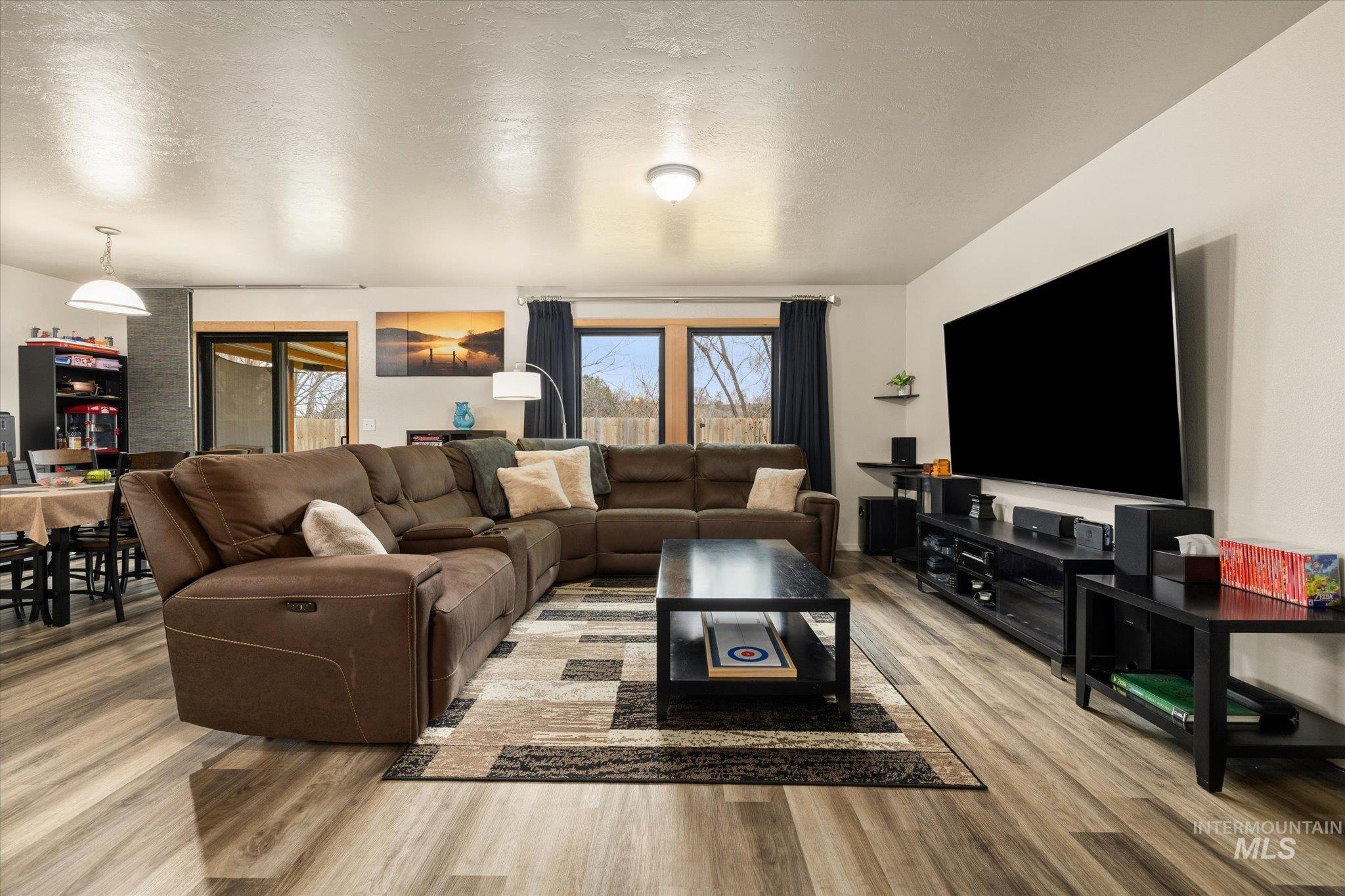 7166 Yellow Fern Road Nampa, ID 83687 - Photo 6 of 35 Living area with light wood-style flooring and a textured ceiling