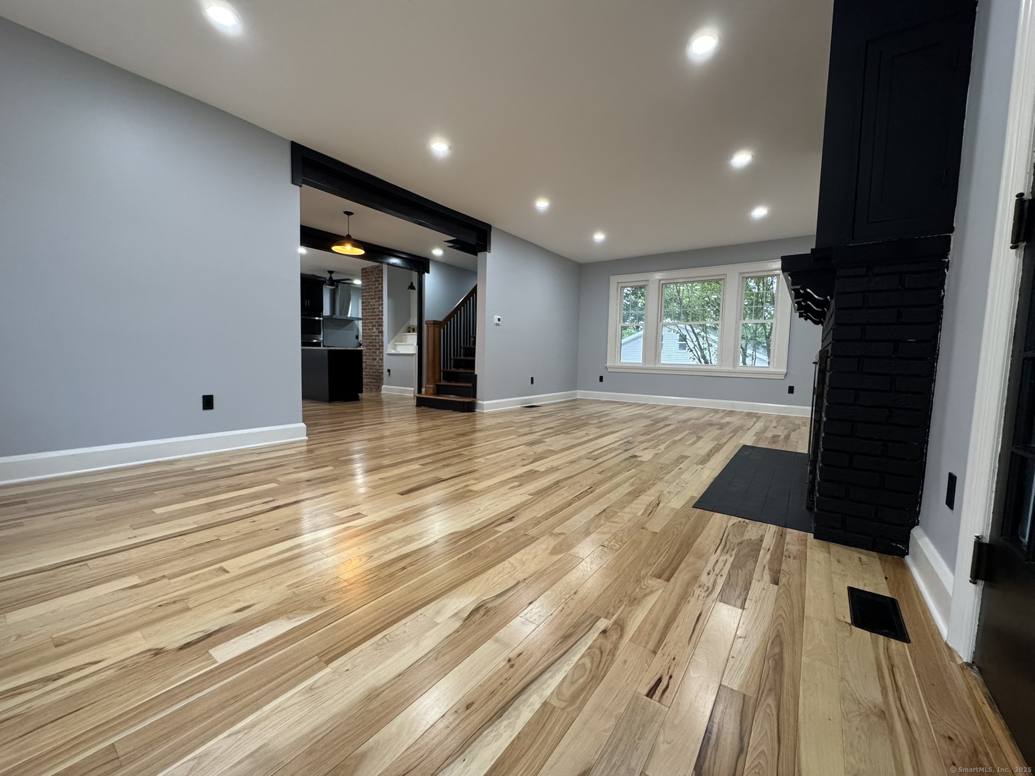 127 Lambert Avenue Meriden, CT 06451 - Photo 11 of 37 a view of an empty room with wooden floor and a window