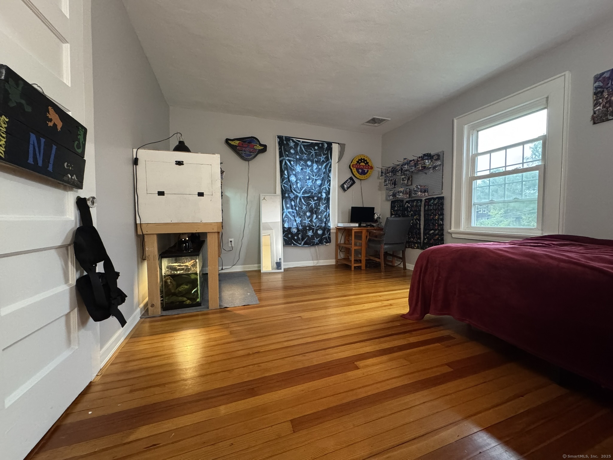 127 Lambert Avenue Meriden, CT 06451 - Photo 21 of 37 a spacious bedroom with a bed and wooden floor